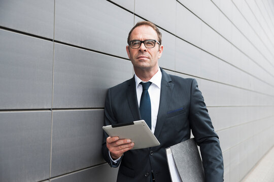 Portrait of Businessman using Tablet Computer Outdoors, Mannheim, Baden-Wurttemberg, Germany