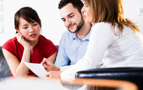 Businesswoman in discussion with young couple, Germany