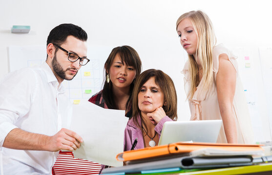 Mature businesswoman meeting and in discussion with group of young business people, Germany