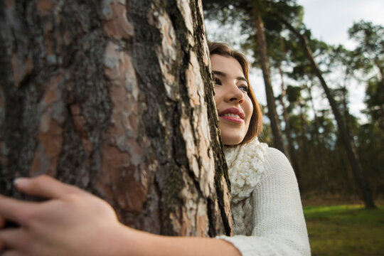 Young Woman Hugging Tree Trunk, Mannheim, Baden-Wurttemberg, Germany