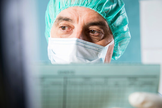 Close-up of Surgeon looking at Medical Chart