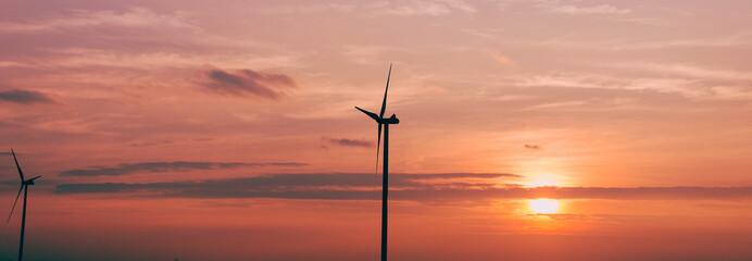 Renewable energy. a windmill for generating electricity from the wind and the sunset behind.  keep environment