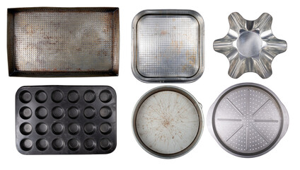 Various old baking trays for baking and preparing cakes and other home baked goods on an isolated background.