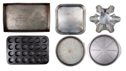 Various old baking trays for baking and preparing cakes and other home baked goods on an isolated background.
