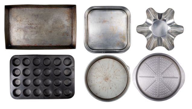 Various old baking trays for baking and preparing cakes and other home baked goods on an isolated background.