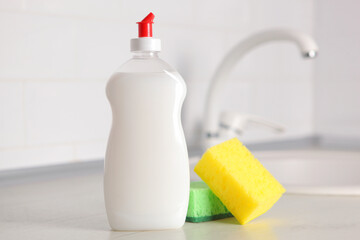 Dishwashing detergent on the background of the kitchen