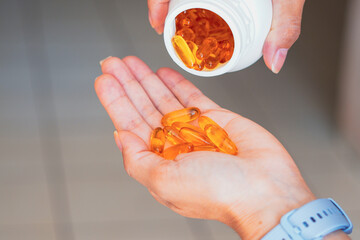 A person holds several medicine pills in his hand