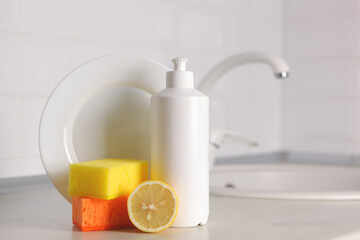 Dishwashing detergent on the background of the kitchen