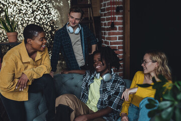 Diverse group of young people, friends, college students gathering together, have fun, playing games, laughing. Concept of diversity, international friendship, learning foreign languages, university