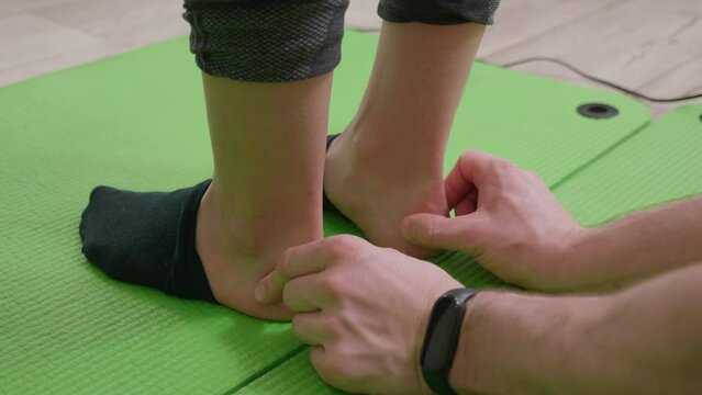 specialist osteopath physiotherapist checks kid leg joints for ligament injuries. scoliosis diagnostics and prevention. close up