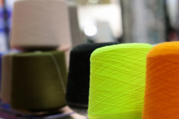 multi-colored wool yarn cones for textile industry