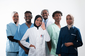 Team or group of a doctor, nurse and medical professional coworkers standing together. Portrait of diverse healthcare workers looking confident. Middle Eastern and African, Muslim medical team. 