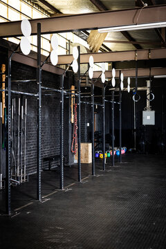 Interior of empty gym with various exercise equipment, copy space