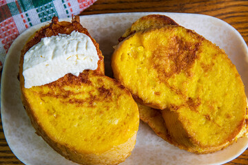 Fried bread with eggs and milk yogurt on a wooden table...