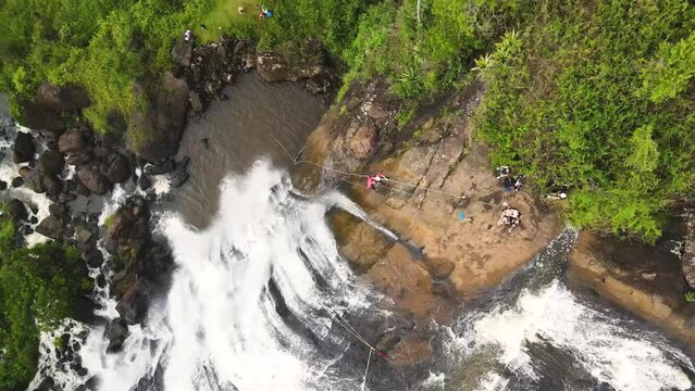 Arc shot of a couple abseiling a waterfall, Brazil, Minas Gerais, aerial view, high angle view