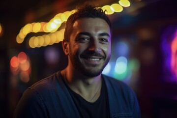 Portrait of handsome young man smiling at the camera in a nightclub