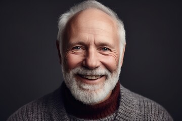 Obraz premium Portrait of a smiling senior man with white beard. Studio shot.