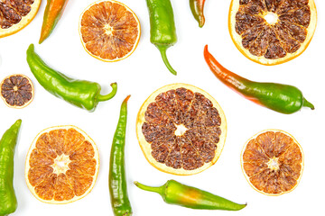 hot green peppers and dried citrus fruit on a white background. grocery organic flatley