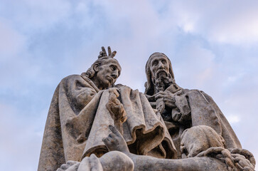 Funny pose of the Statue of St. Cyril and St. Methodius on Charles Bridge in Prague. 