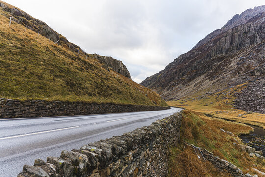 Open road leading between the mountains at Snowdonia national park in North Wales. High quality photo