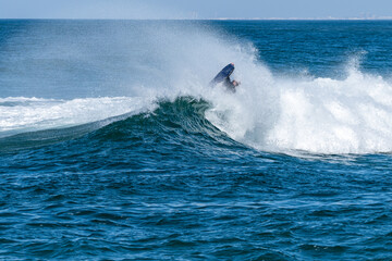 Bodyboarder surfing ocean wave