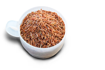 Sangyod brown rice in a measuring cup with clipping path.