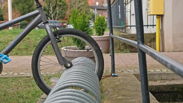 Kid Bike Parked at Bikestand by School Building
