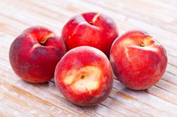 Naklejka na ściany i meble Delicious ripe peaches fruit on wooden surface close up