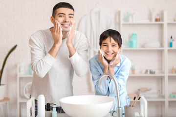 Morning of father and his little son shaving in bathroom