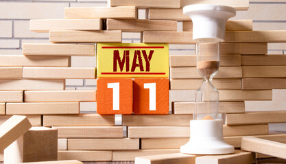 day on the calendar, May 11 on wooden block