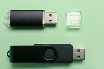 USB flash drives on green background