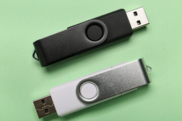 USB flash drives on green background