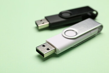 USB flash drives on green background