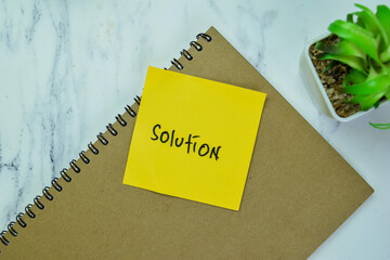 Concept of Solution write on book isolated on Wooden Table.