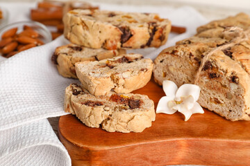 Wooden board with delicious biscotti cookies, closeup