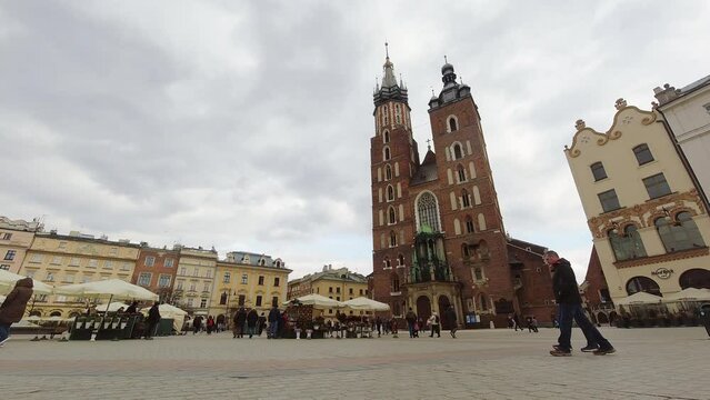 Krakow, Poland - 6th march, 2023: Krakow city main square Rynek Glowny static time lapse. Polish citizen in public collects charity donations for Ukraine war victims.