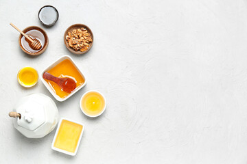 Obraz na płótnie Canvas Bowls of honey and nuts on white background