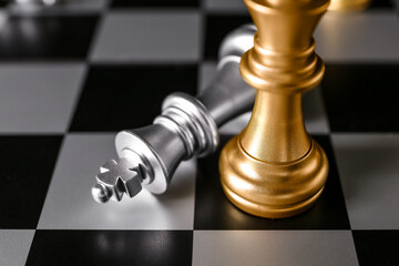 Chess pieces on board, closeup. Loser concept
