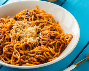 A white plate of Spaghetti with minced meat