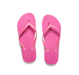 Pair of pink flip-flops on white background