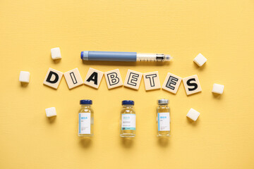 Word DIABETES with insulin and sugar on yellow background