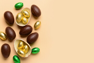 Chocolate Easter eggs on beige background