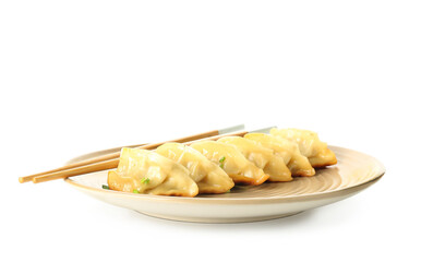 Plate with tasty Chinese jiaozi and green onion on white background