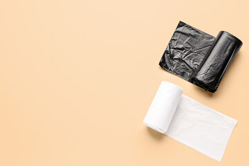 Different rolls of garbage bags on beige background