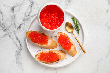 Tasty bruschettas with red caviar on grunge background