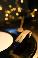 Record player with vinyl disk and glowing lights, closeup