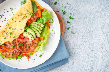 Tasty omelet with vegetables on color grunge background