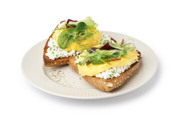 Plate with tasty scrambled eggs sandwiches and greens on white background