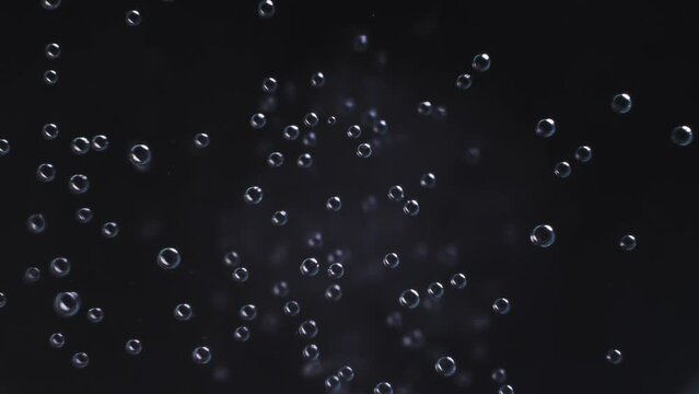 Top view closeup scene on chaotic moving pattern of bubble isolated on black background, fizz texture of soda water drink when gas release, massive of small balloon flowing in the air