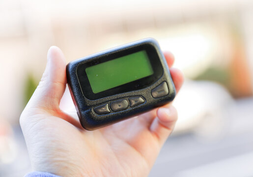 Pager is a small wireless device that receives and displays numeric or text messages, symbolizing the era of technological advancements in communication and transition from analog to digital device